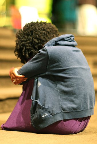 Black woman praying silently and soberly for justice issues
