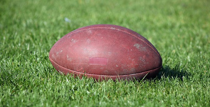Football in grass. Licensed from Dreamstime.