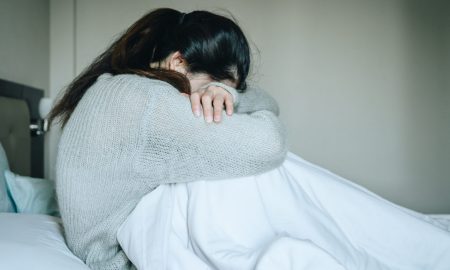 Image of woman crying with her head down. loss, abortion, Japan, miscarriage, abortion pill