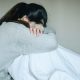 Image of woman crying with her head down. loss, abortion, Japan, miscarriage, abortion pill